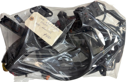 Black motorcycle parts in a clear plastic bag on a white surface