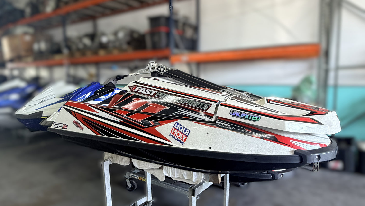 Model speedboat on display in a warehouse setting