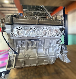 Remanufactured Kawasaki 300HP supercharged engine core exchange unit by MIAMIJETSKIMOTORSPORTS, showing engine components and branding.