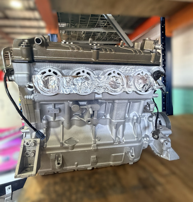 Remanufactured Kawasaki 300HP supercharged engine core exchange unit by MIAMIJETSKIMOTORSPORTS, showing engine components and branding.