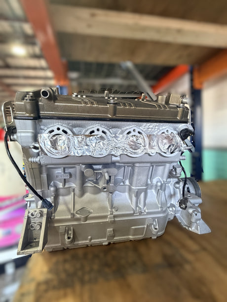 Remanufactured Kawasaki Ultra 250 engine, complete long block, showing detailed internal components for core exchange program.