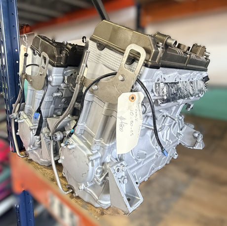 Remanufactured Kawasaki Ultra 250 engine long block in silver with visible components, designed for core exchange.